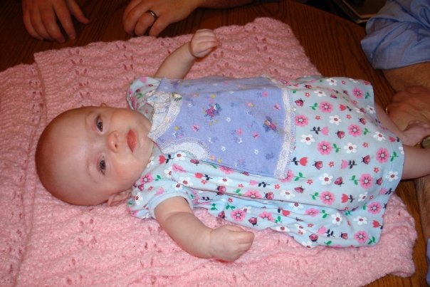 Becca in her new dress - with her first dress ever laying on top of her.  Wow!