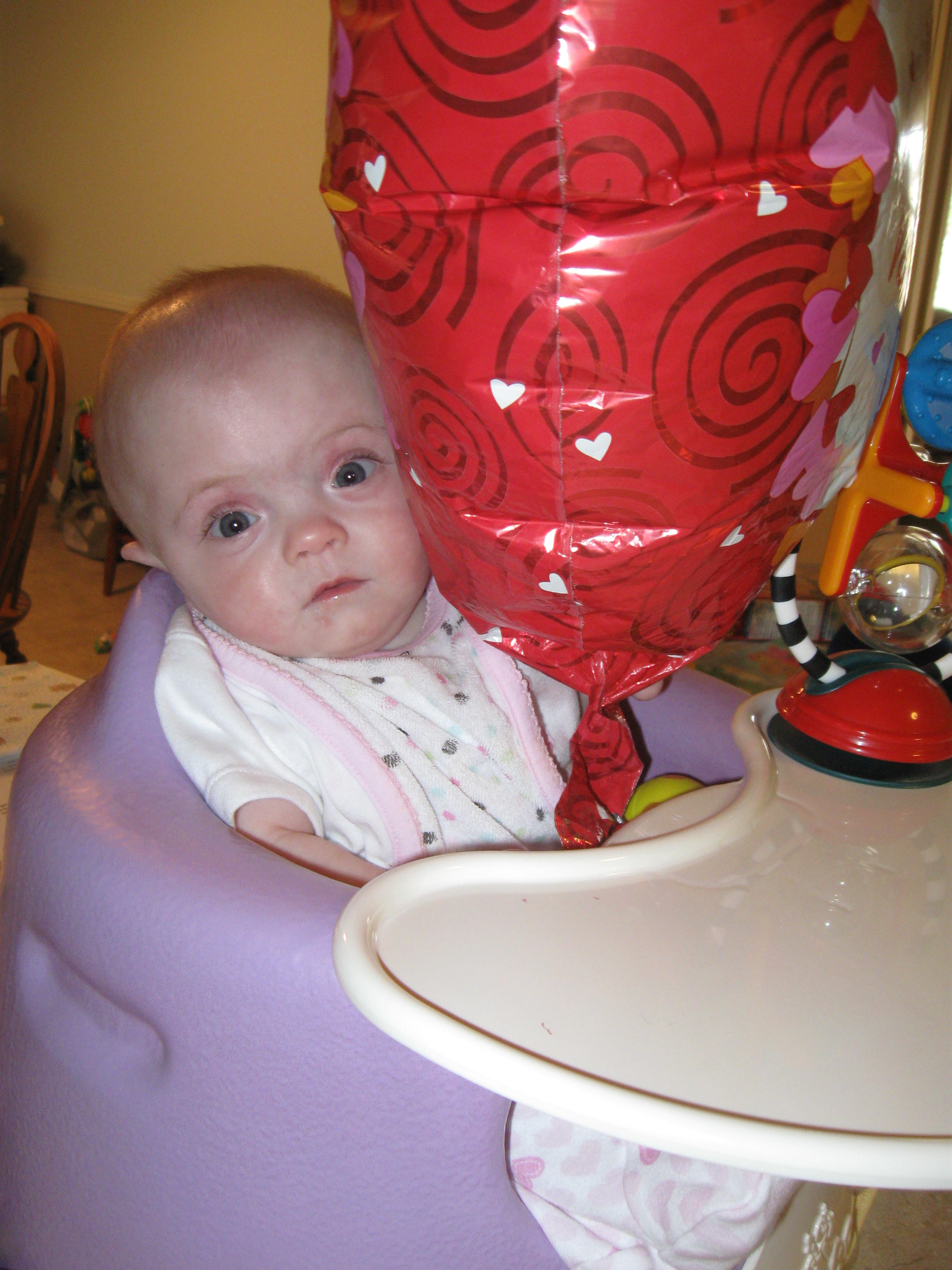 Here she's peeking out from behind her new favorite toy - and Mom's best deal ever - a crinkly mylar balloon from Dollar Tree.  What a great deal!